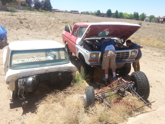 Working and trying to get it running and the torn down parts bronco next to it.